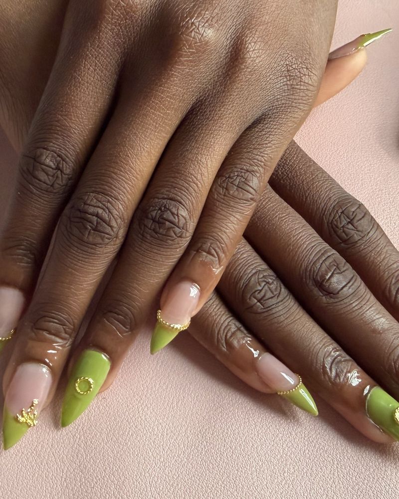 Green stiletto nails with gold detailing