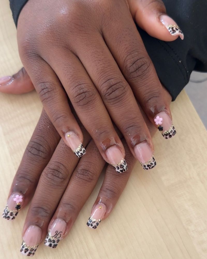 Leopard print French tips with gold glitter and pink flower charms