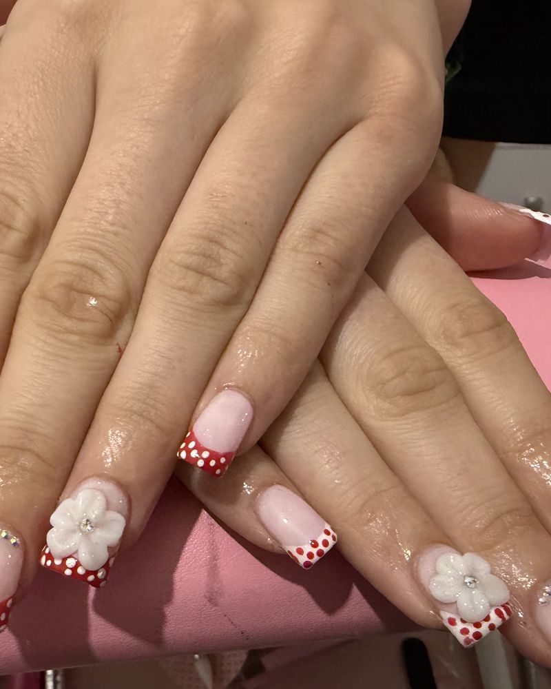 Red and white polka dot French tips with 3D white flowers